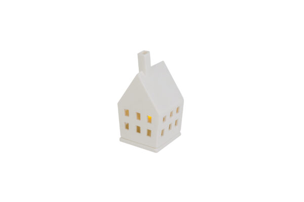 De Keramiek theelichthuis mat met DORSETTO is een witte theelichthouder in de vorm van een huis van keramiek met een schoorsteen en vierkante ramen, zacht oplichtend met geel licht, afgebeeld tegen een effen witte achtergrond.